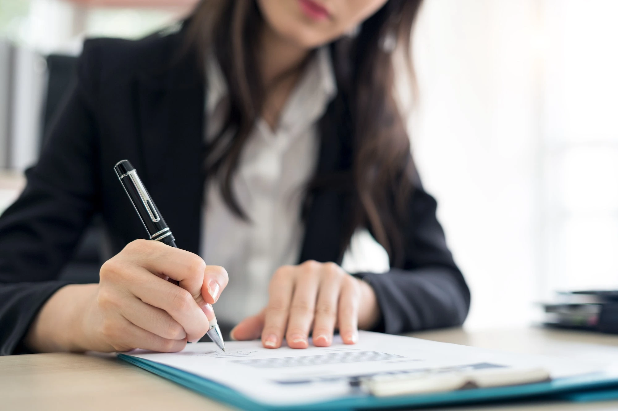 Businesswoman signing contract.